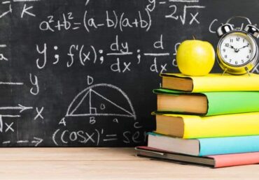 school-desk-with-textbooks-near-blackboard Най-честите грешки в НВО по математика в 7. клас и как да ги избегнем